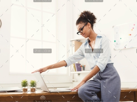 demo-attachment-184-business-woman-opening-laptop-at-office-PU4ZAGW